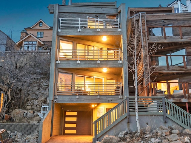 rear view of property featuring a balcony