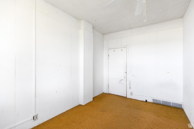 spare room featuring visible vents, ceiling fan, and carpet floors