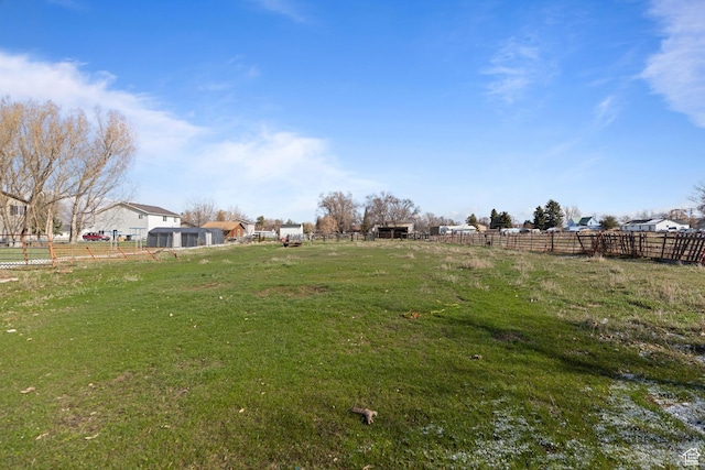 view of yard featuring fence and a rural view