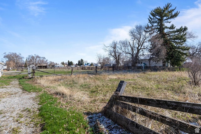 view of yard with a rural view and fence