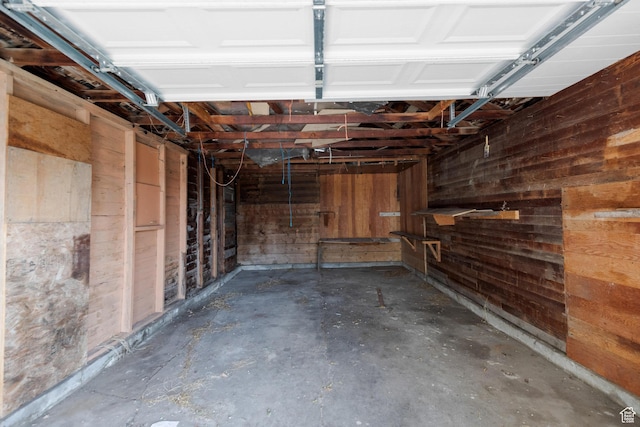 garage featuring wooden walls