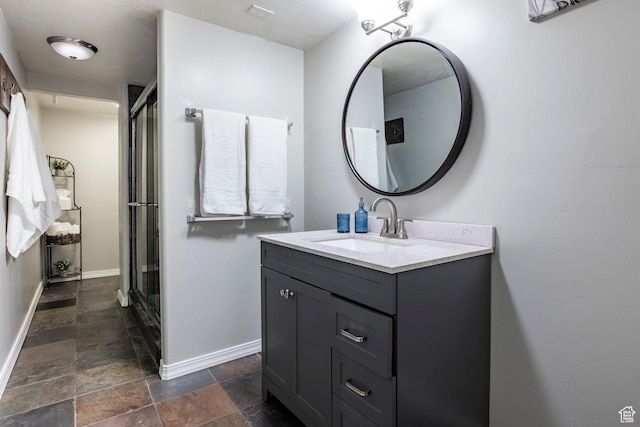 12268 N Ross Creek Dr, Kamas, UT 84036 - full bathroom featuring vanity, stone tile floors, baseboards, and an enclosed shower