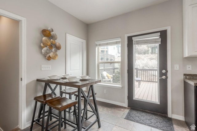 12268 N Ross Creek Dr, Kamas, UT 84036 - dining room featuring baseboards and light stone finish floors