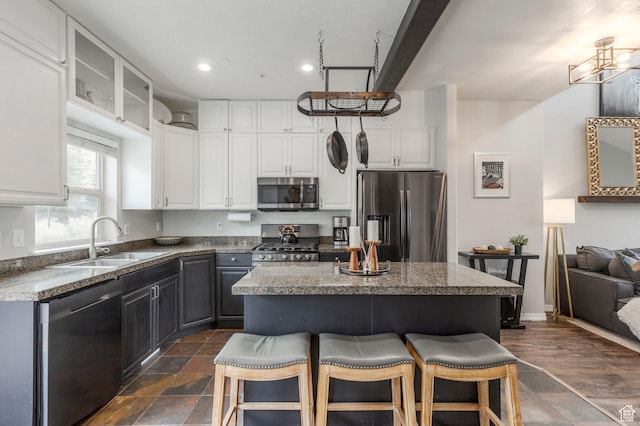 12268 N Ross Creek Dr, Kamas, UT 84036 - kitchen featuring appliances with stainless steel finishes, a sink, a breakfast bar area, white cabinetry, and recessed lighting