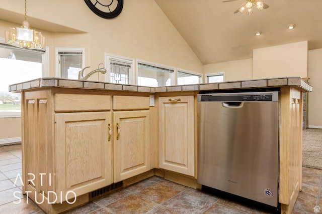 kitchen with dishwasher, light brown cabinets, a ceiling fan, and lofted ceiling