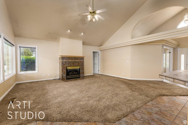 unfurnished living room featuring baseboards, a fireplace, carpet flooring, a ceiling fan, and high vaulted ceiling