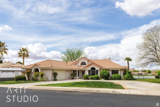 mediterranean / spanish house with stucco siding, a chimney, driveway, a tile roof, and a garage