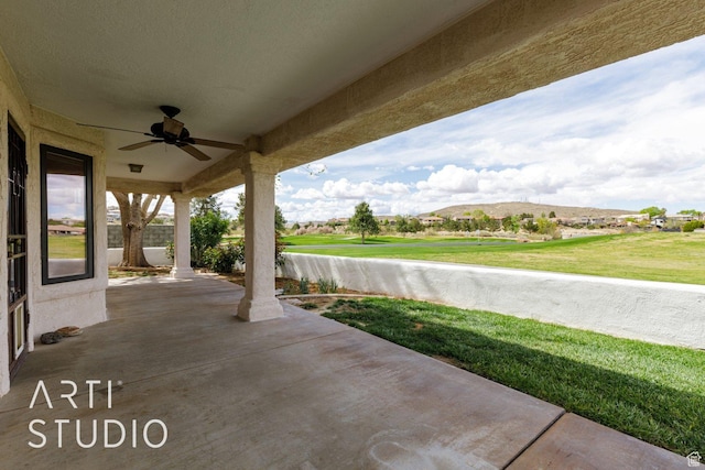 view of patio featuring ceiling fan