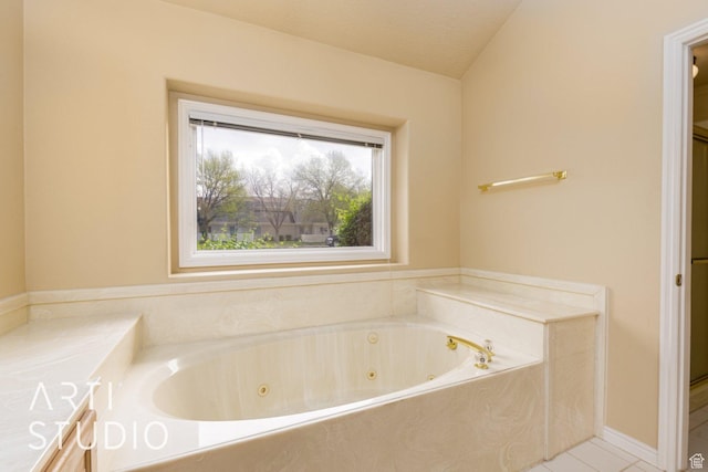 bathroom with a whirlpool tub, tile patterned floors, and a textured ceiling
