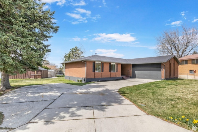 ranch-style home featuring concrete driveway, brick siding, a garage, and a front lawn