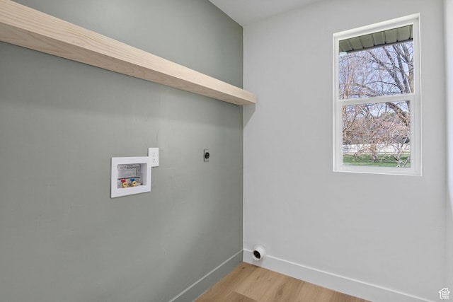 washroom featuring laundry area, hookup for a washing machine, light wood-type flooring, hookup for an electric dryer, and baseboards
