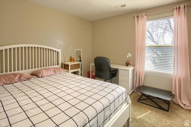 carpeted bedroom with visible vents