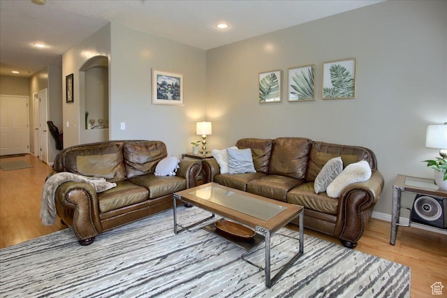 living room featuring recessed lighting, light wood-style floors, and baseboards