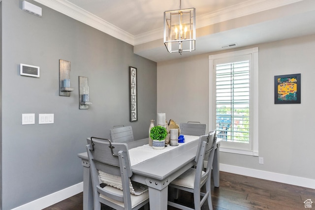 dining area with visible vents, baseboards, a notable chandelier, dark wood-style flooring, and crown molding
