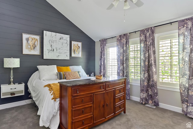 bedroom featuring light carpet, baseboards, multiple windows, and lofted ceiling