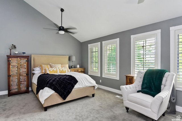 carpeted bedroom featuring multiple windows, baseboards, a ceiling fan, and lofted ceiling