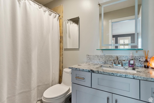 bathroom featuring vanity and toilet