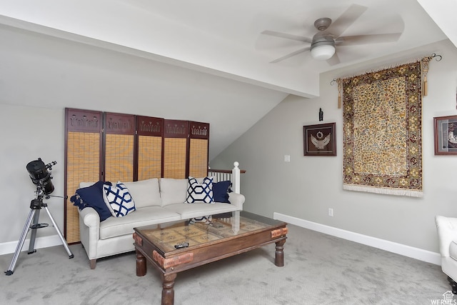 carpeted living area with lofted ceiling with beams, a ceiling fan, and baseboards