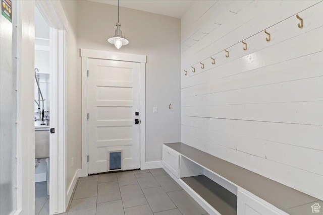 mudroom featuring light tile patterned flooring and baseboards