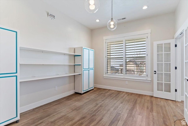 interior space with visible vents, baseboards, recessed lighting, and wood finished floors