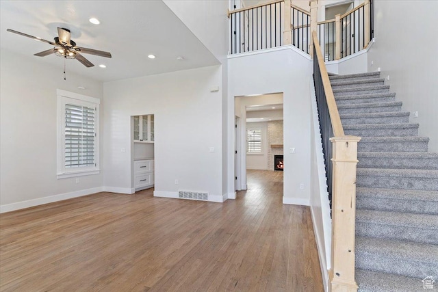 interior space featuring visible vents, baseboards, a ceiling fan, recessed lighting, and wood finished floors