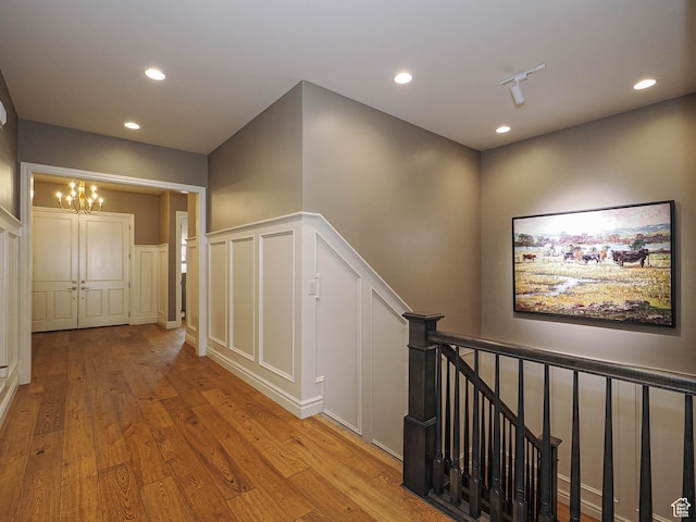 1979 E Olympus Point Dr, Holladay, UT 84117 - hall featuring a chandelier, wood finished floors, an upstairs landing, and recessed lighting