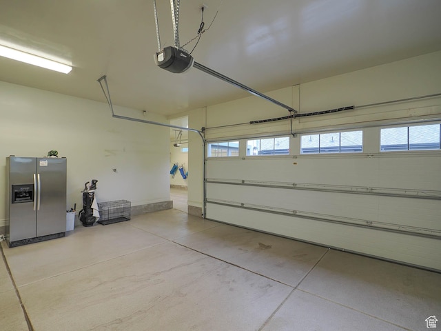 1979 E Olympus Point Dr, Holladay, UT 84117 - garage featuring a garage door opener and stainless steel fridge