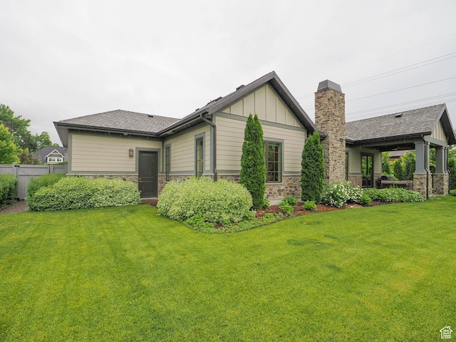 1979 E Olympus Point Dr, Holladay, UT 84117 - exterior space featuring a yard, fence, stone siding, and board and batten siding