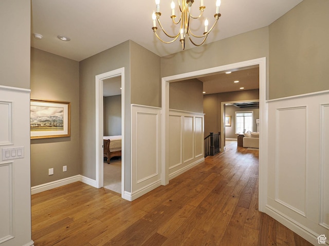 1979 E Olympus Point Dr, Holladay, UT 84117 - corridor featuring a chandelier, recessed lighting, wainscoting, a decorative wall, and wood-type flooring