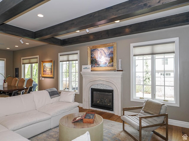1979 E Olympus Point Dr, Holladay, UT 84117 - living area with beamed ceiling, a glass covered fireplace, recessed lighting, wood finished floors, and baseboards