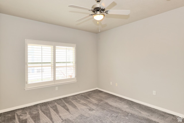 carpeted empty room featuring baseboards and a ceiling fan