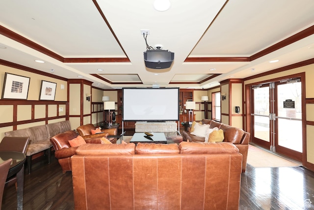 cinema room featuring crown molding, a raised ceiling, and hardwood / wood-style floors