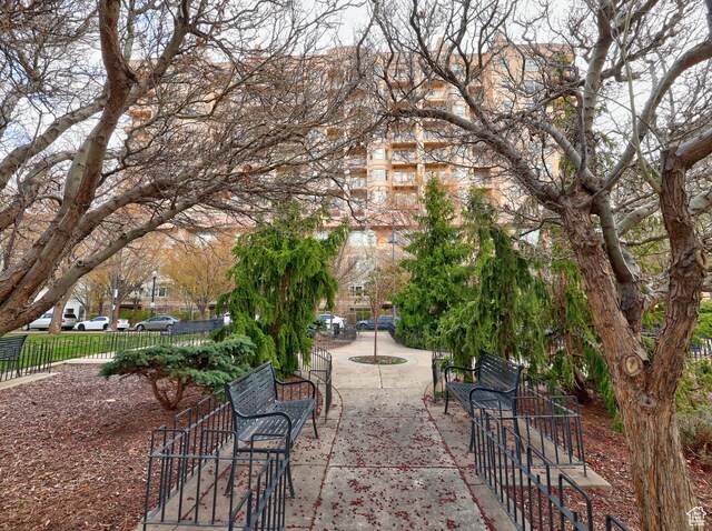 view of property's community with fence and a patio