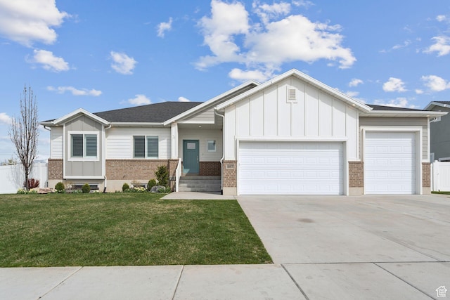 view of front of home with a garage, brick siding, driveway, and board and batten siding