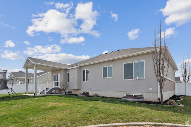 887 S 3050 W, Syracuse, UT 84075 - back of house with a trampoline and stucco siding