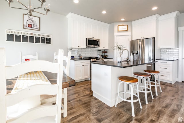 887 S 3050 W, Syracuse, UT 84075 - kitchen featuring stainless steel appliances, dark countertops, decorative backsplash, recessed lighting, and white cabinets