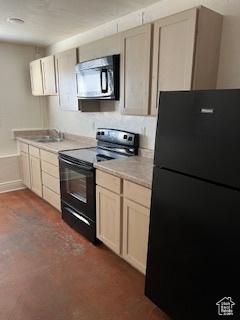 56 E Center St Unit 1, Richfield, UT 84701 - kitchen with black appliances, baseboards, a sink, and light countertops