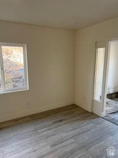 56 E Center St Unit 1, Richfield, UT 84701 - unfurnished room featuring baseboards, wood finished floors, and plenty of natural light