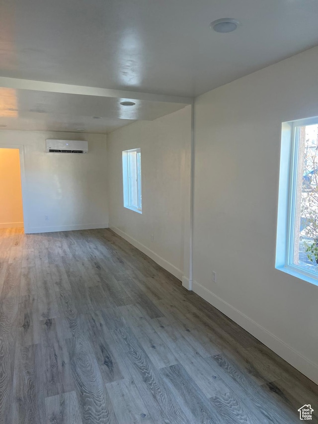 56 E Center St Unit 1, Richfield, UT 84701 - spare room with plenty of natural light, a wall mounted air conditioner, and wood finished floors