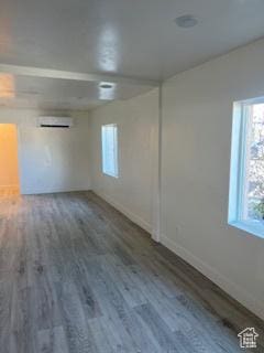 56 E Center St Unit 1, Richfield, UT 84701 - spare room with baseboards, wood finished floors, and a wall unit AC