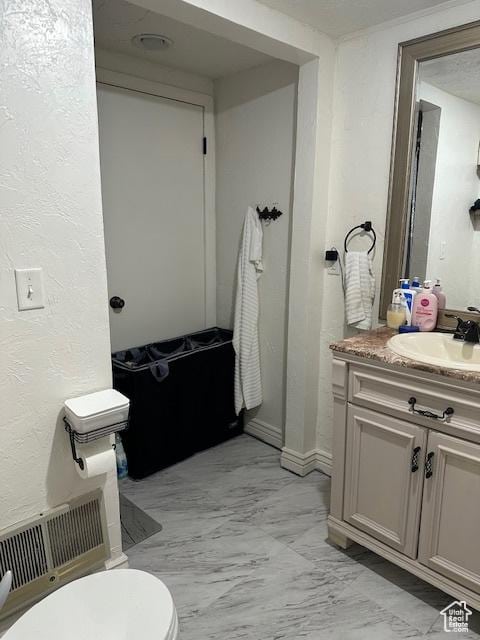 56 E Center St Unit 1, Richfield, UT 84701 - bathroom with vanity, a textured wall, and marble finish floors