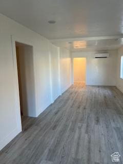 56 E Center St Unit 1, Richfield, UT 84701 - unfurnished room with a wall mounted AC, wood finished floors, and baseboards