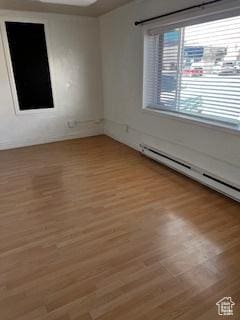 56 E Center St Unit 1, Richfield, UT 84701 - unfurnished room featuring a baseboard heating unit and light wood finished floors