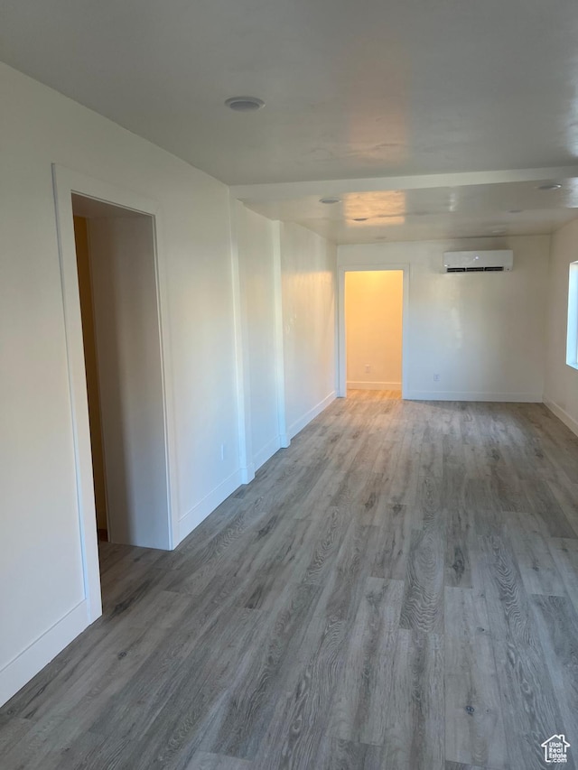 56 E Center St Unit 1, Richfield, UT 84701 - empty room featuring a wall mounted air conditioner and wood finished floors