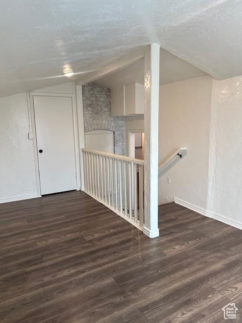 56 E Center St Unit 1, Richfield, UT 84701 - unfurnished room featuring vaulted ceiling, wood finished floors, and a textured ceiling
