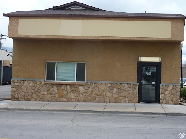 view of front of house with stone siding and stucco siding