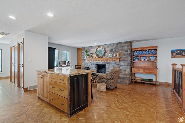 1850 E Cottonwood Club Dr, Holladay, UT 84117 - kitchen featuring visible vents, a kitchen island, and a textured ceiling