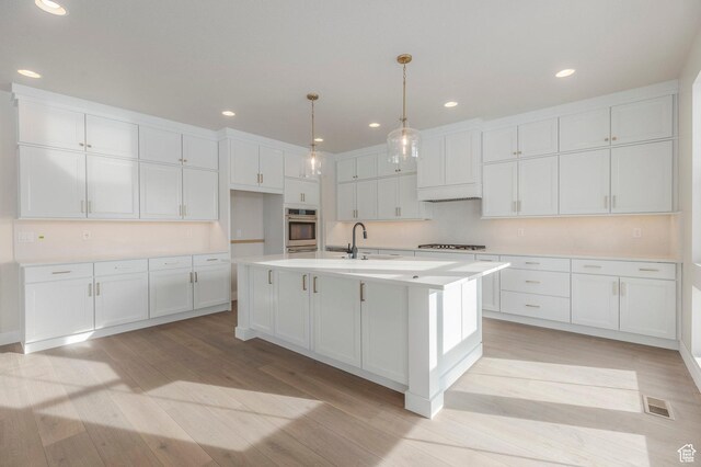 2989 Rock View Dr Unit 105, Francis, UT 84036 - kitchen featuring light countertops, white cabinets, light wood-style floors, gas stovetop, and stainless steel oven