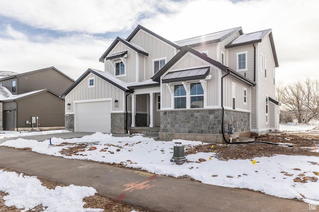 2989 Rock View Dr Unit 105, Francis, UT 84036 - view of front of home with board and batten siding, an attached garage, stone siding, and driveway