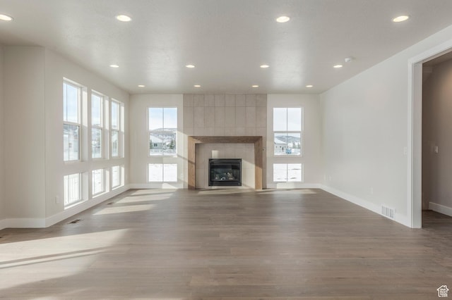 2989 Rock View Dr Unit 105, Francis, UT 84036 - unfurnished living room featuring recessed lighting, a tile fireplace, visible vents, and wood finished floors